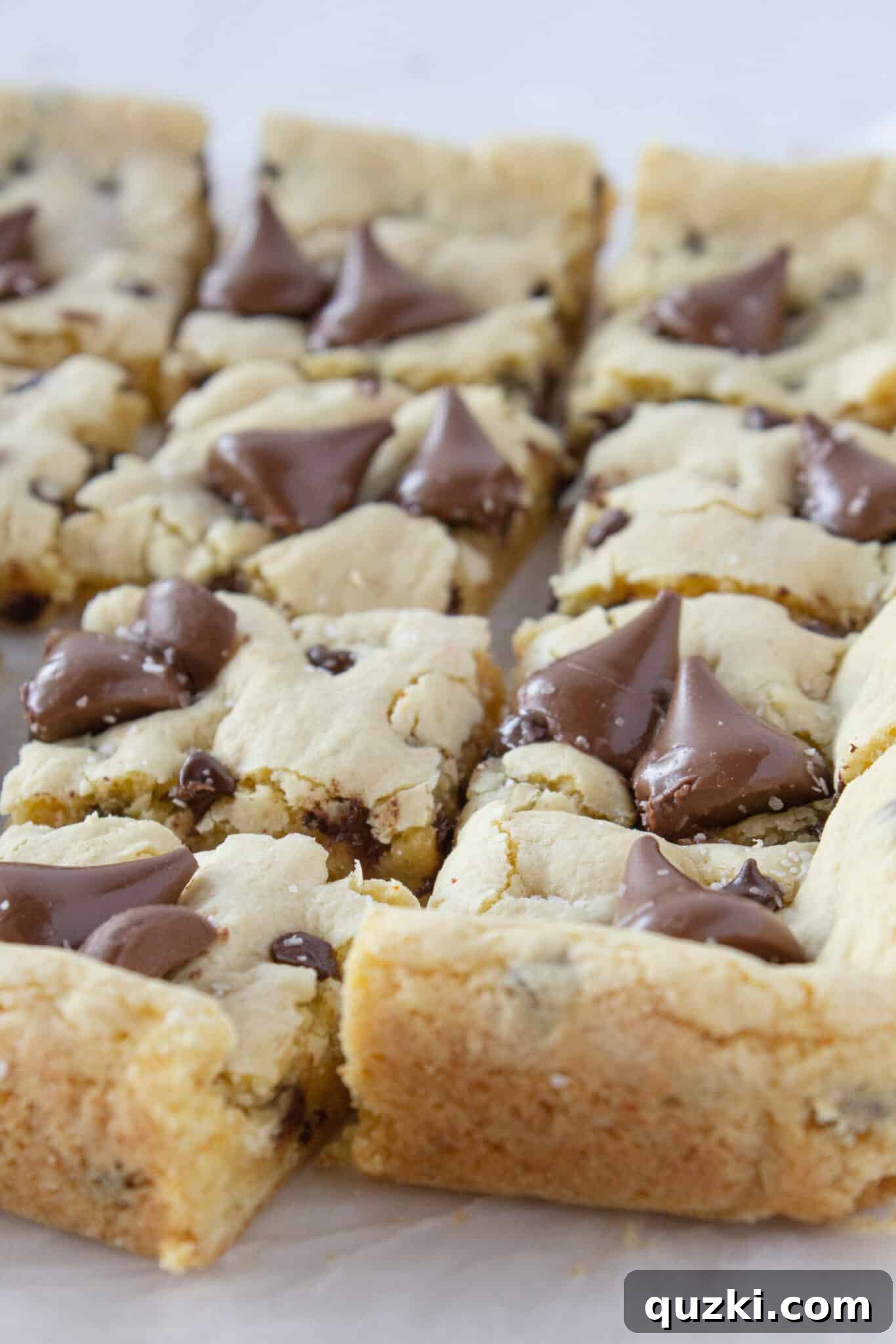 Toasted Butter Hershey Kiss Cookie Bars 3 Squares of delicious Brown Butter Hershey's Kiss Cookie Bars displayed artfully on a serving tray.