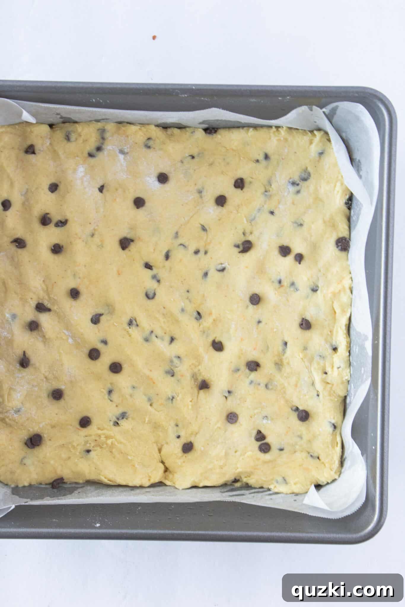 Toasted Butter Hershey Kiss Cookie Bars 6 Cookie dough pressed into a pan and partially baked, ready for Hershey's Kisses.