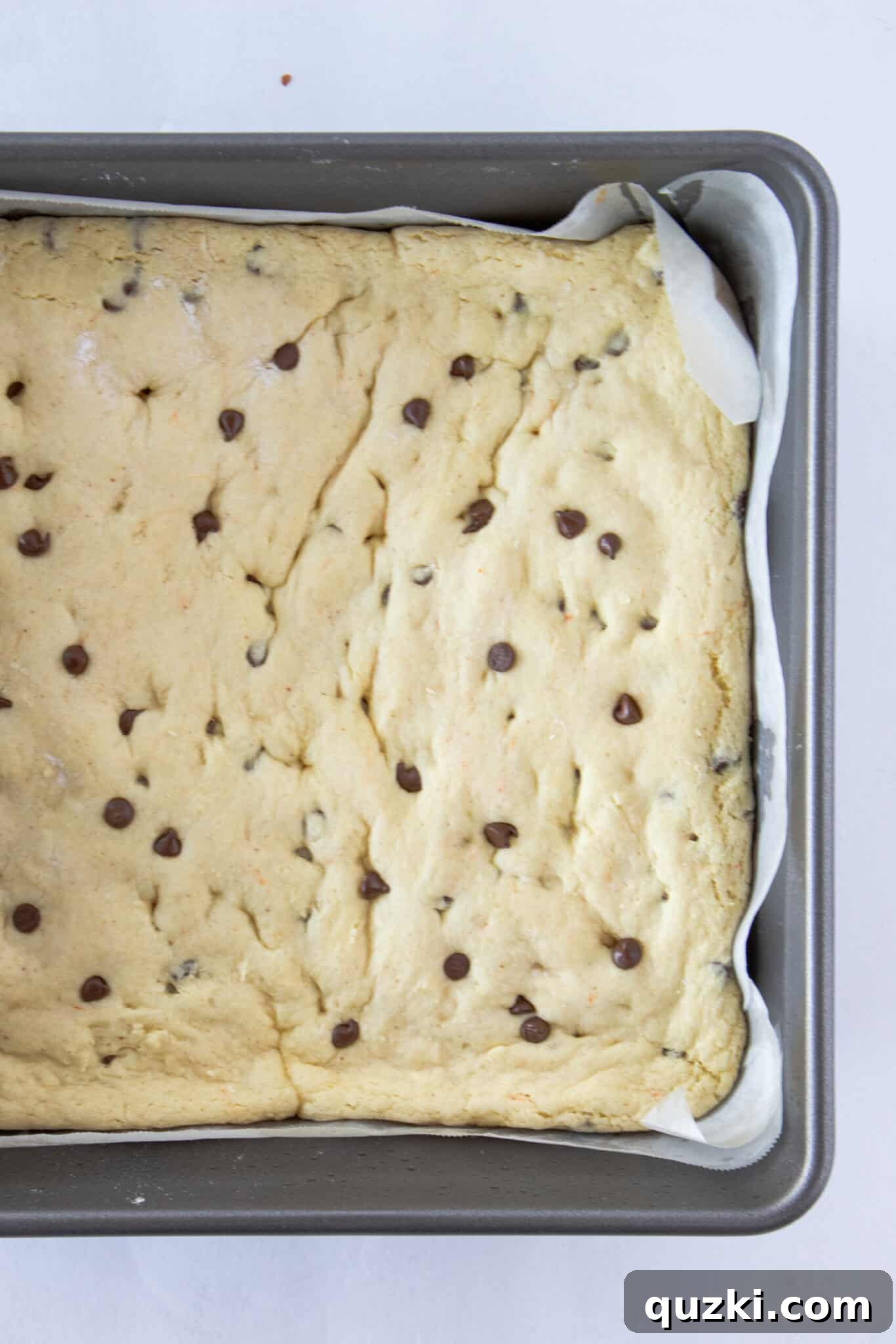 Toasted Butter Hershey Kiss Cookie Bars 7 Preparing the cookie dough for baking: pressing it into the pan and showing it after the initial bake.