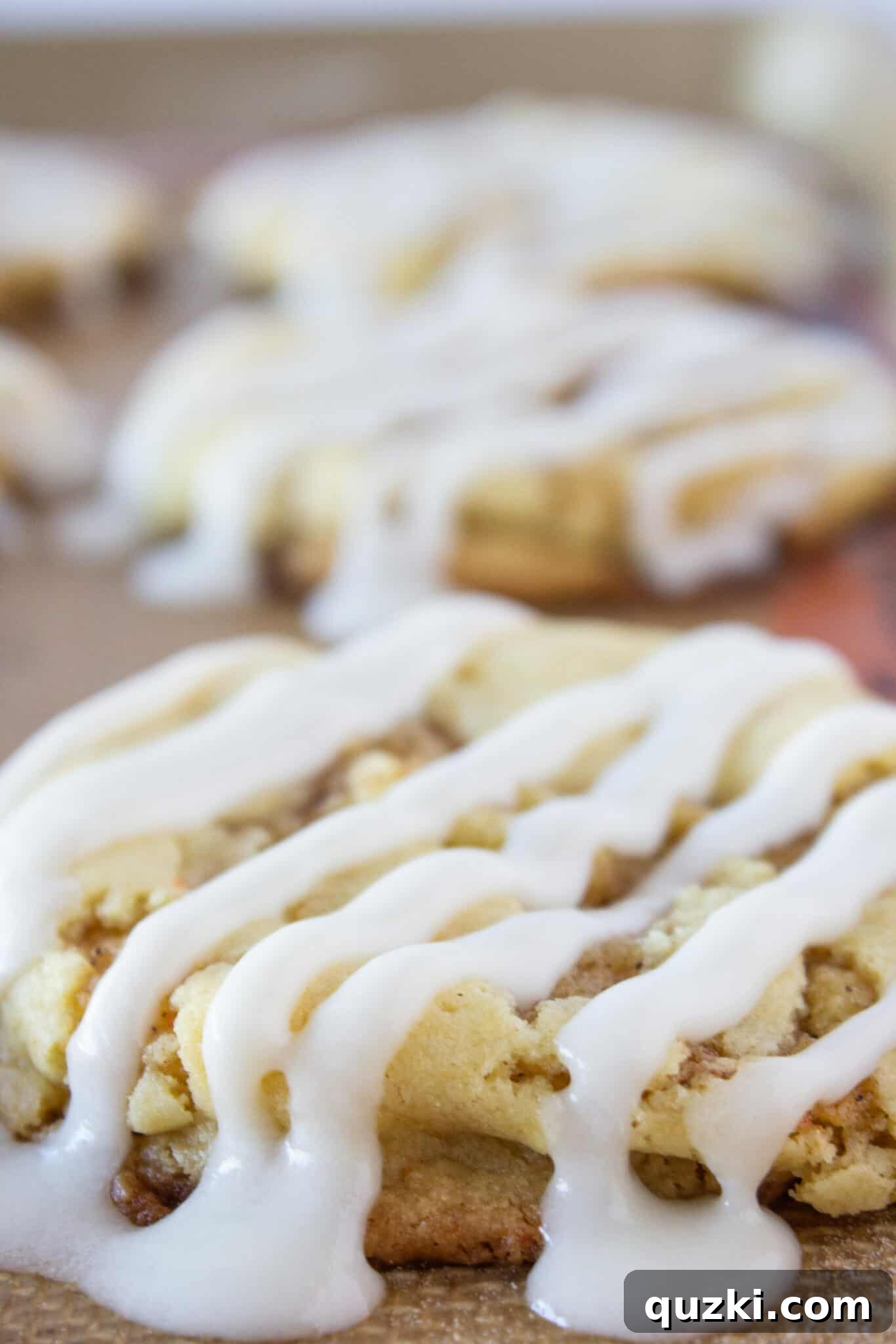 Cinnamon roll cookies generously drizzled with sweet glaze