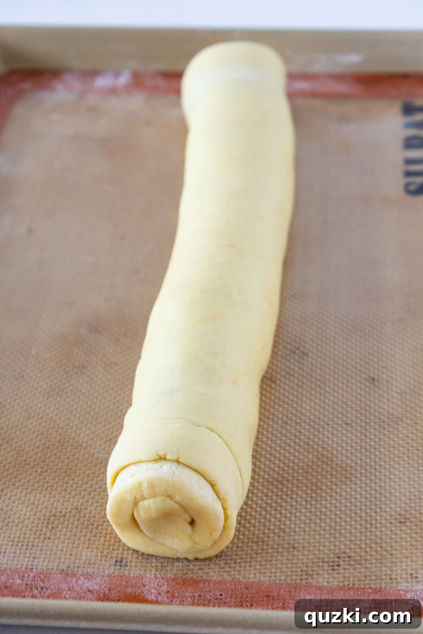 Cookie dough log tightly rolled with cinnamon filling inside