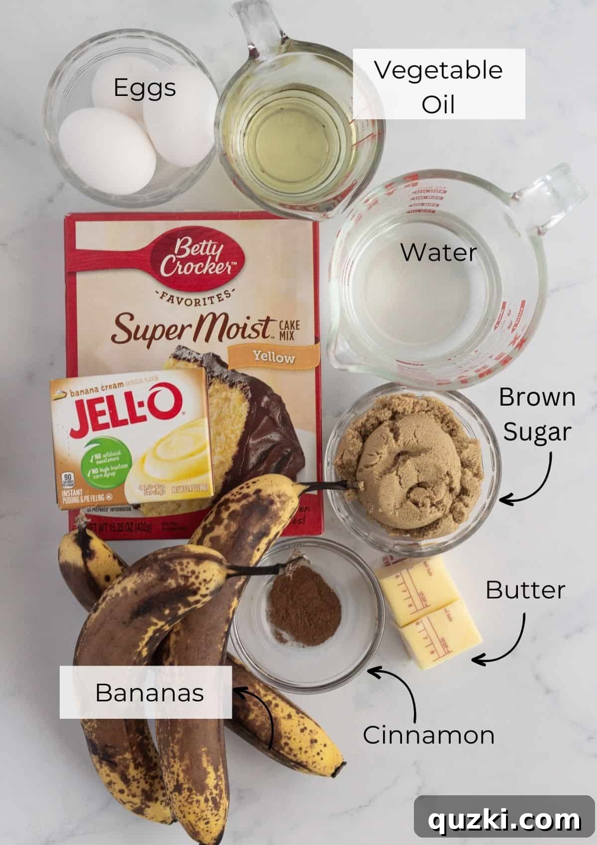 Moist Banana Bundt Magic 3 All the essential ingredients for making a delicious Banana Upside Down Cake laid out on a white surface.