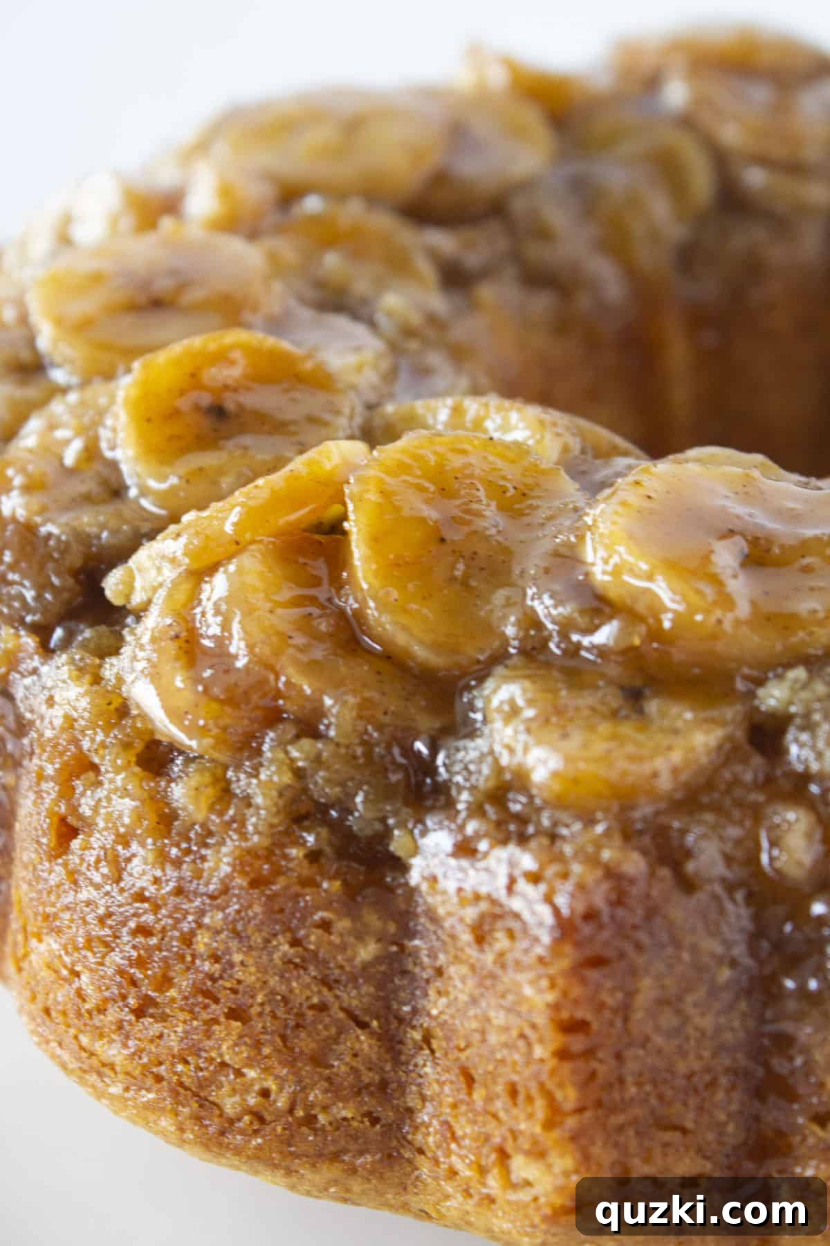 Moist Banana Bundt Magic 7 A close-up of a slice of banana upside down cake showing the perfectly caramelized banana slices and moist cake interior.