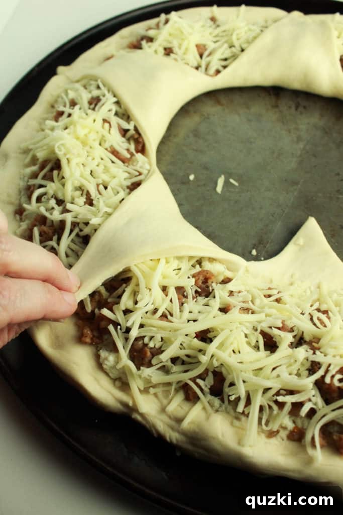 Stuffed Italian Sausage and Ricotta Pizza Ring 7 The Italian Sausage Ricotta Pizza Ring, perfectly assembled and ready for baking, showcasing its beautiful star-folded design.