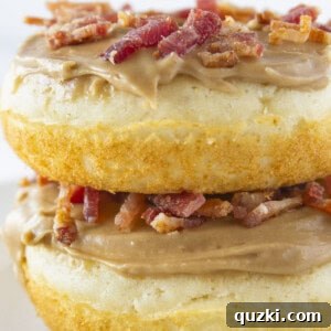 Two maple bacon donuts stacked on each other.
