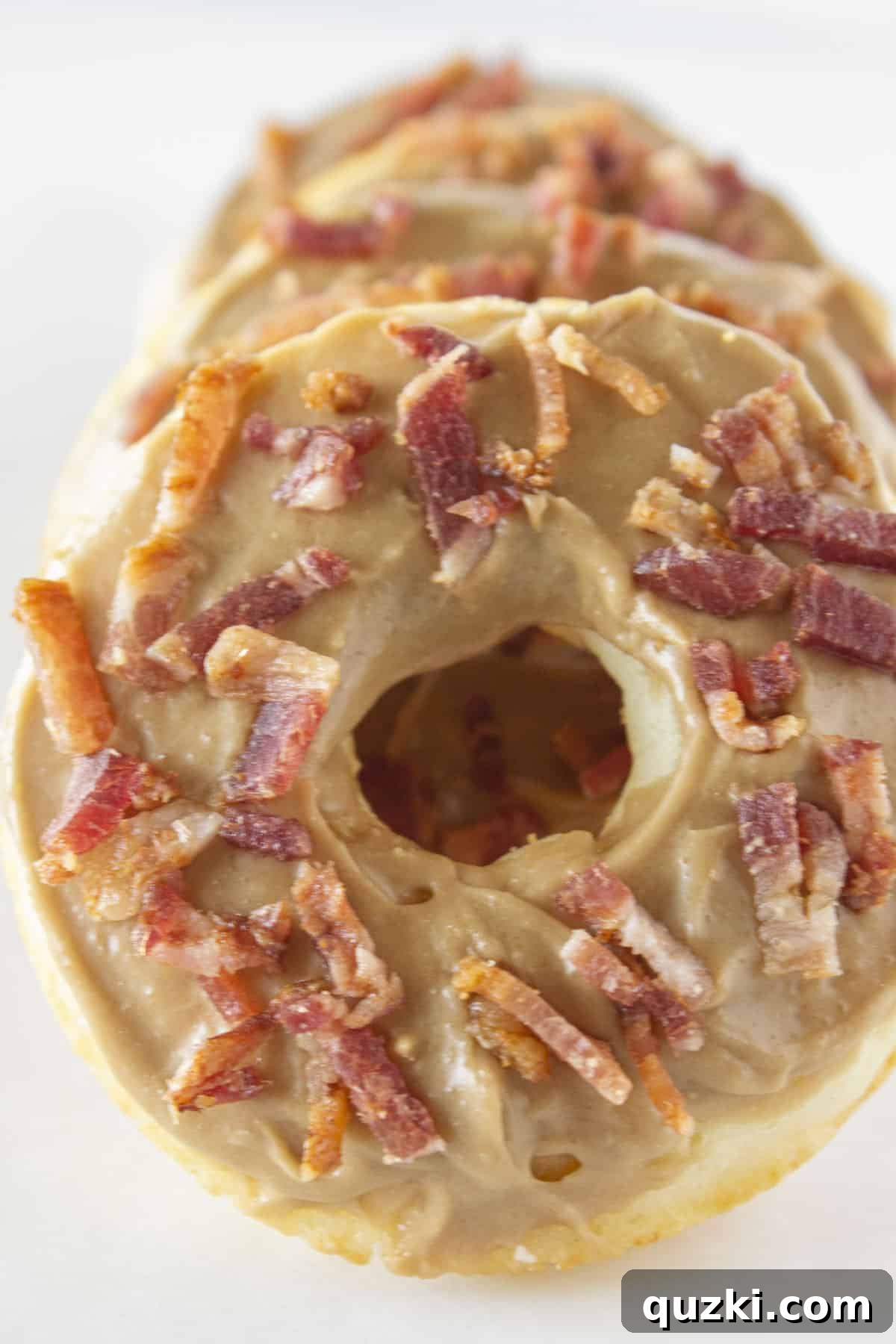 Sweet and Savory Maple Bacon Baked Donut Delight 7 A stack of maple bacon donuts made with pancake mix, ready to be enjoyed.