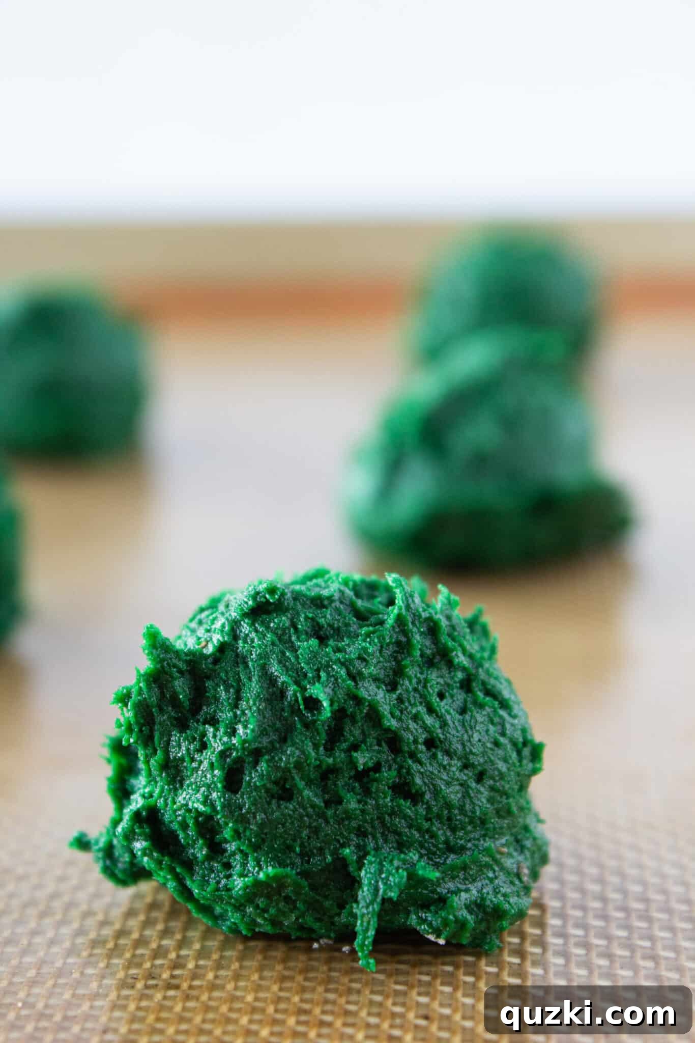 Effortless Green Velvet Cake Mix Cookies 6 Scooped green velvet cookie dough on a baking sheet before going into the oven.
