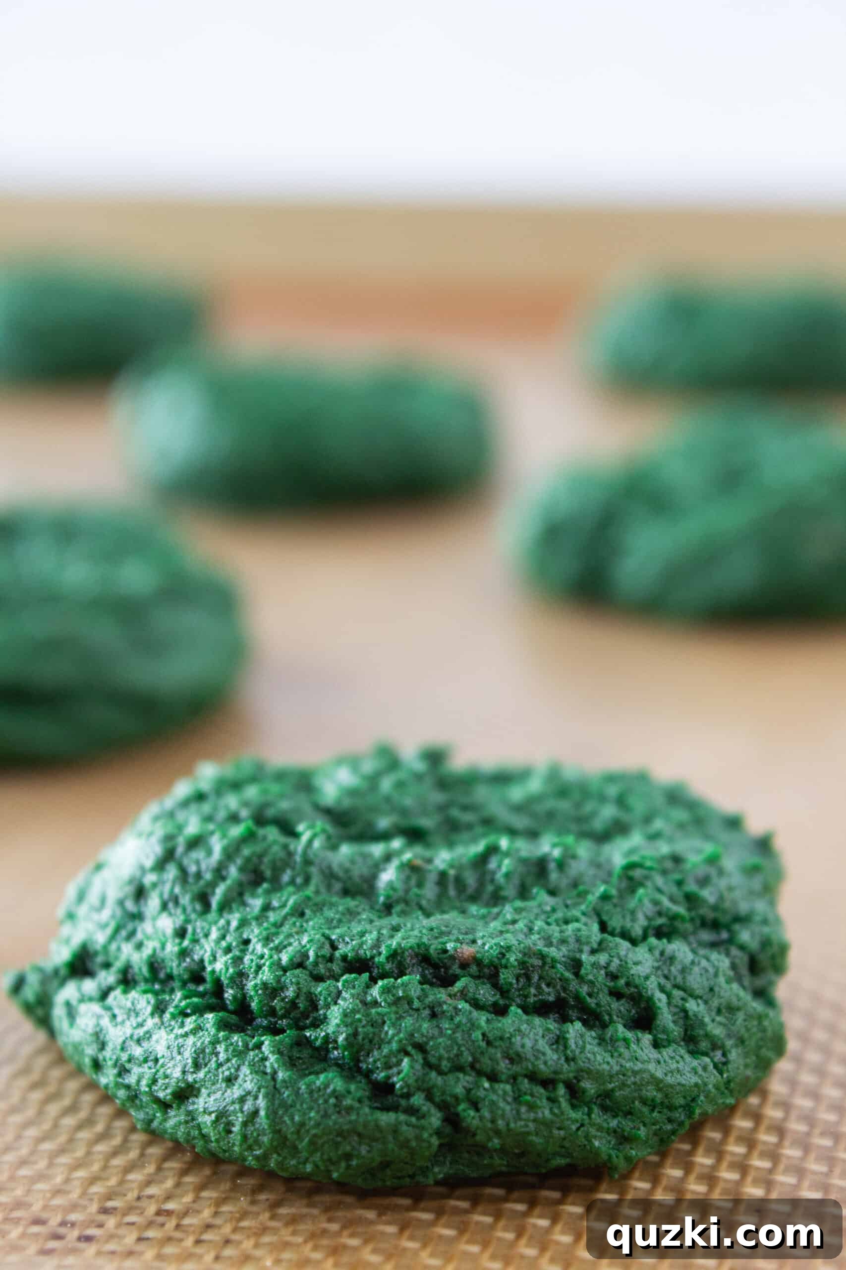 Effortless Green Velvet Cake Mix Cookies 7 Baked Green Velvet Cream Cheese Cookies cooling on a wire rack.