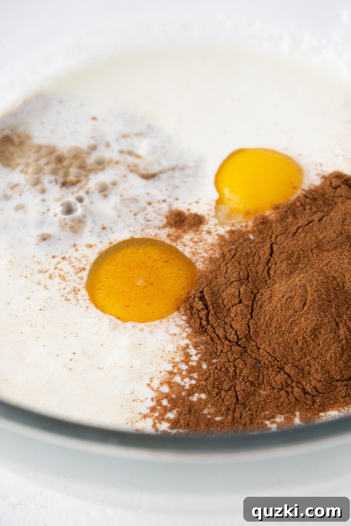 Adding the french toast batter ingredients into a bowl.