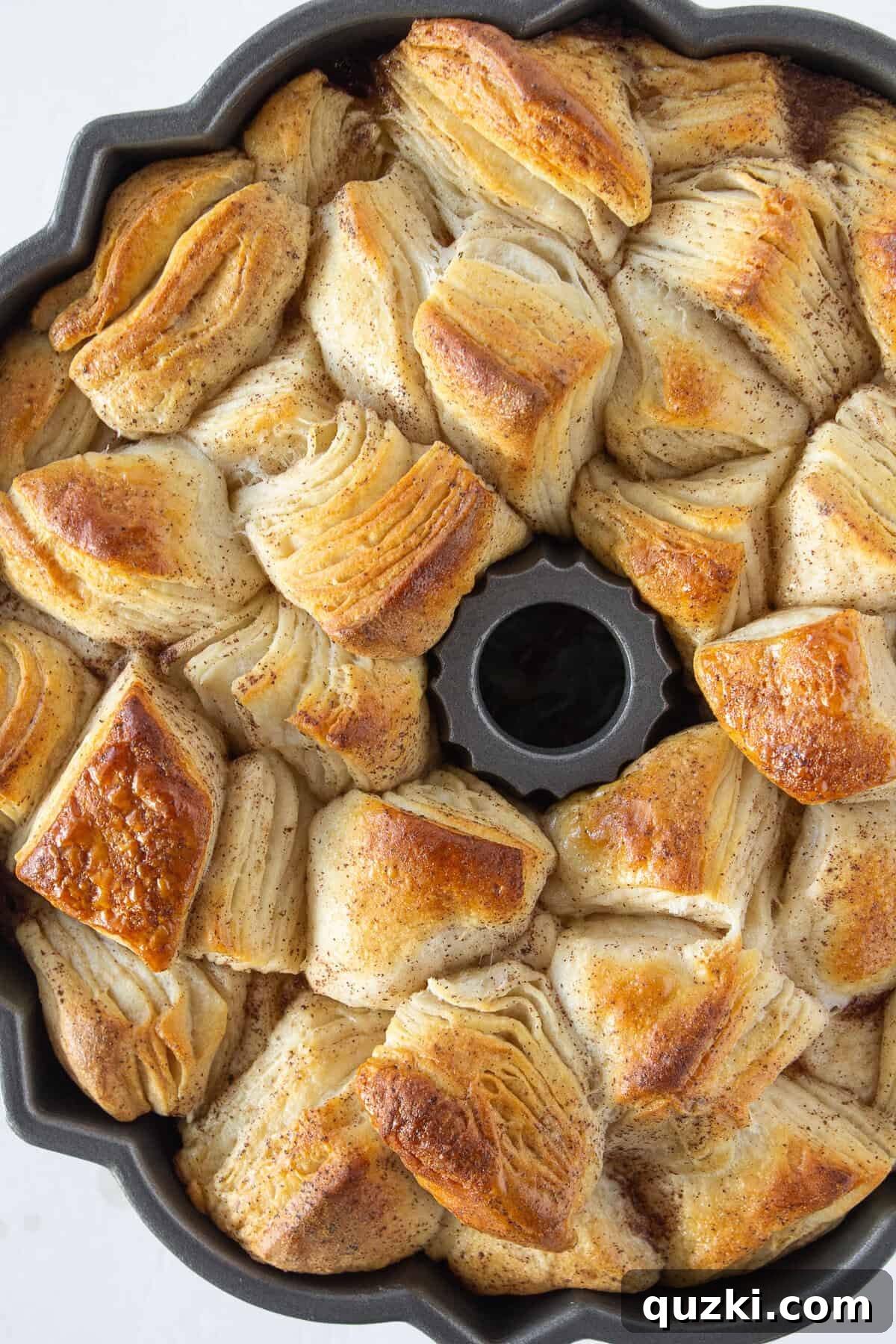 Cooling the monkey bread for a few minutes before inverting onto a cake plate.