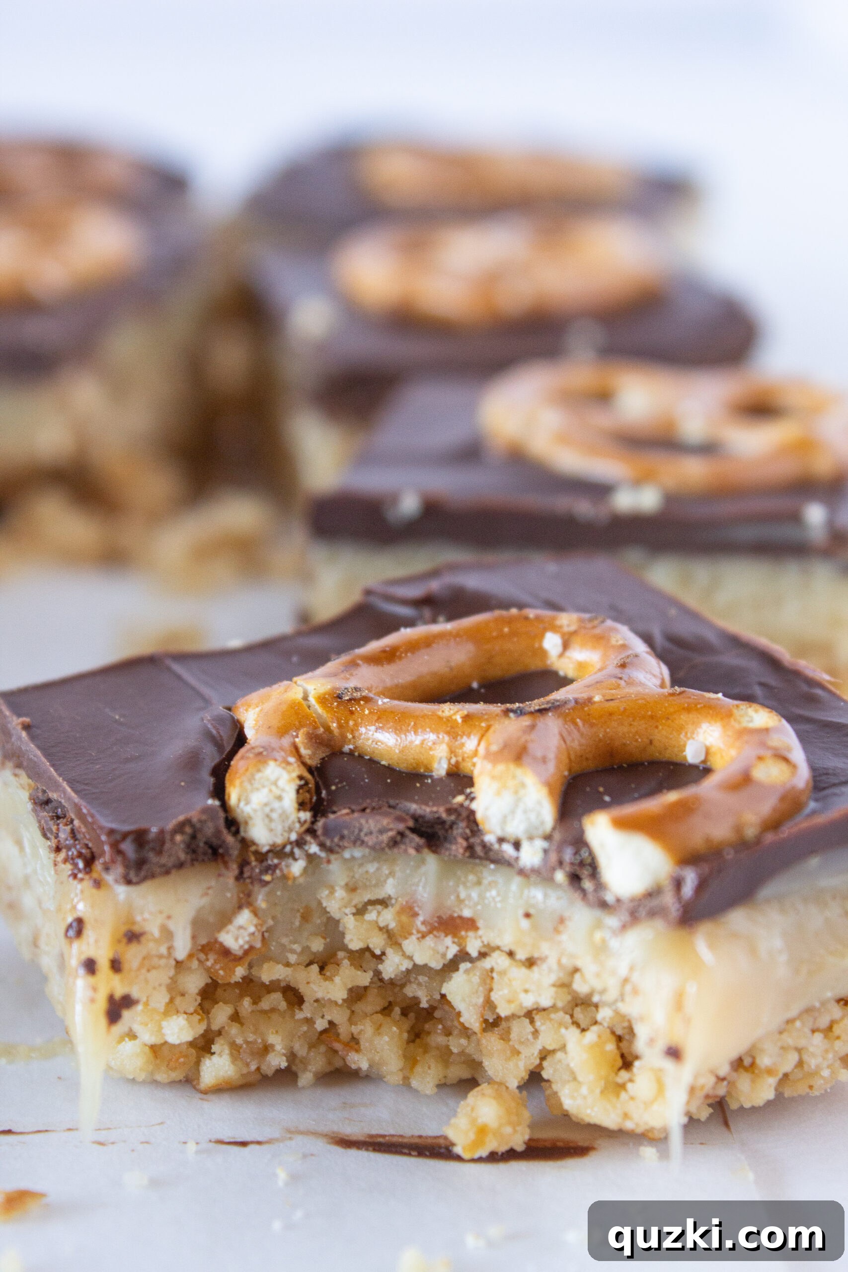 Easy No Bake Millionaire Bars Recipe with a rich pretzel crust, featured by top US dessert blogger, Practically Homemade