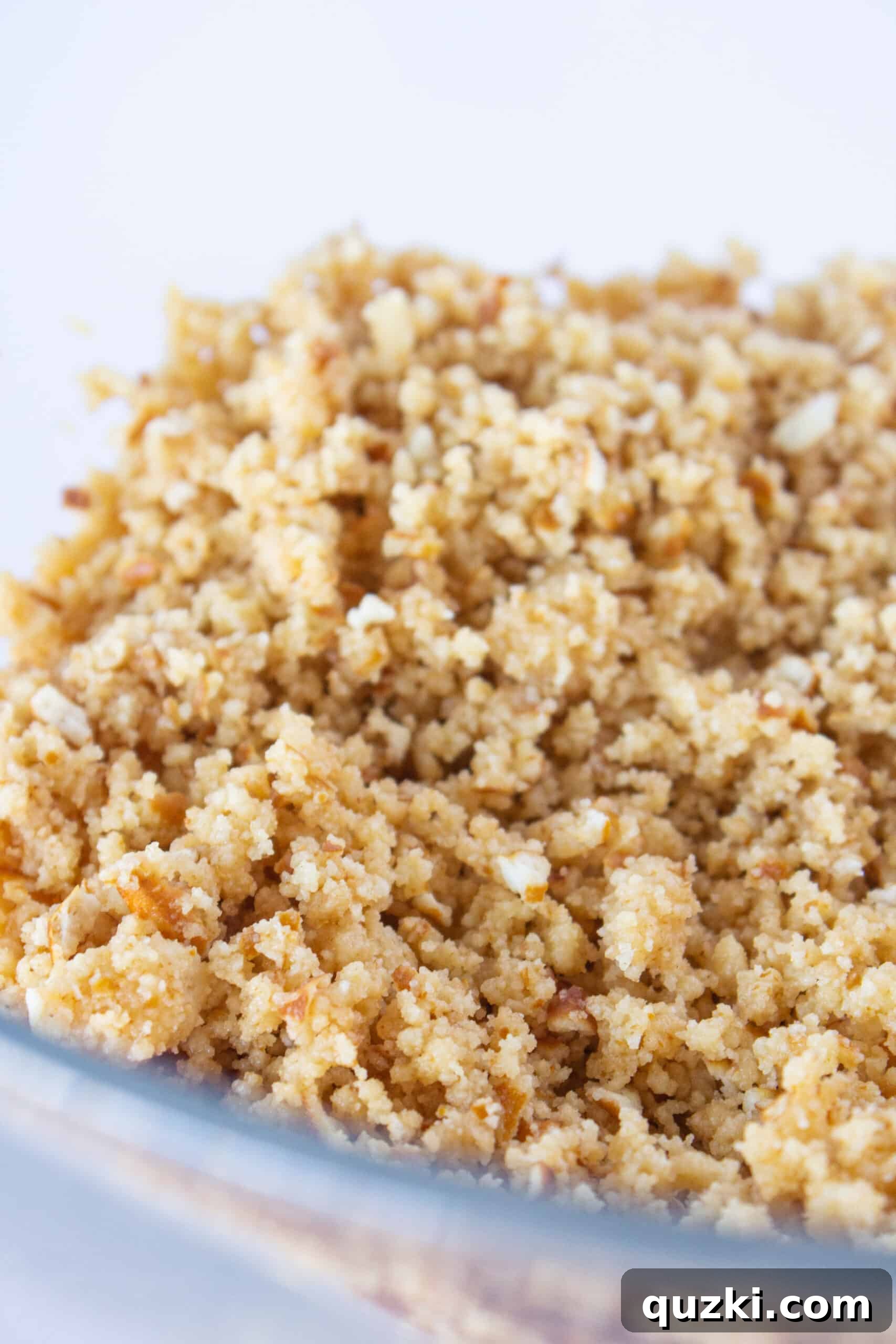 Melted butter added to shortbread and pretzel crumbs for Millionaire Bars crust