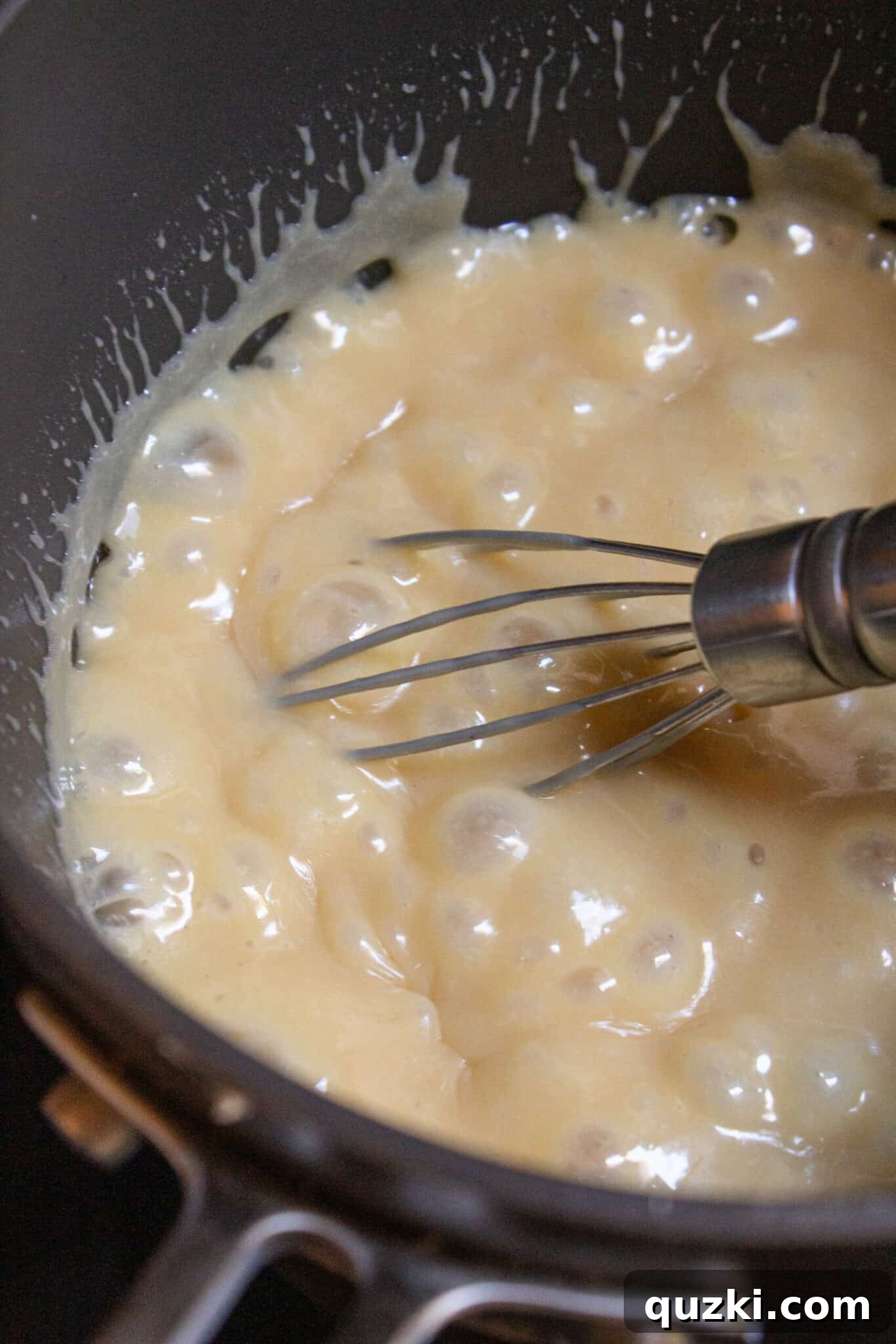 Pouring the thick, golden caramel layer over the chilled pretzel crust