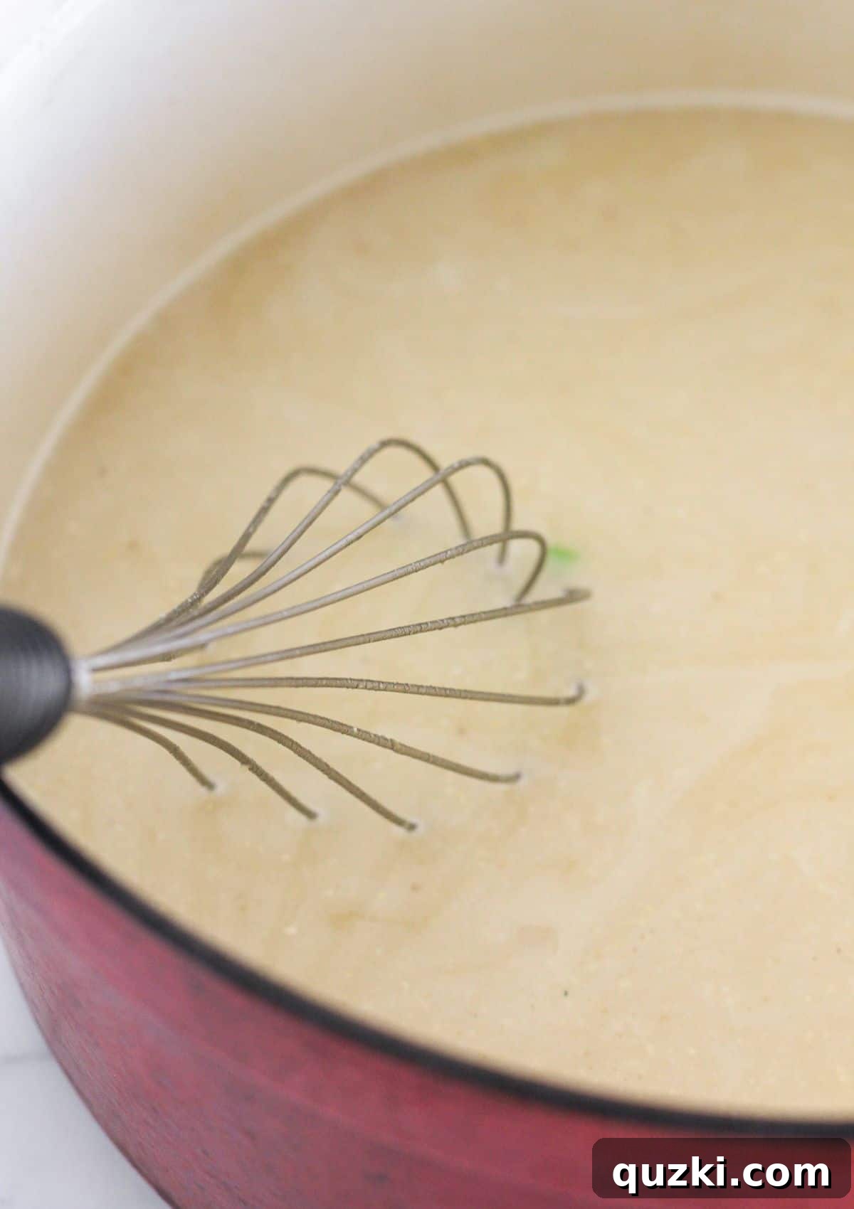 Effortless 20 Minute Chicken Enchilada Soup 5 Whisking chicken broth into the masa flour mixture in a pot to create a smooth soup base.