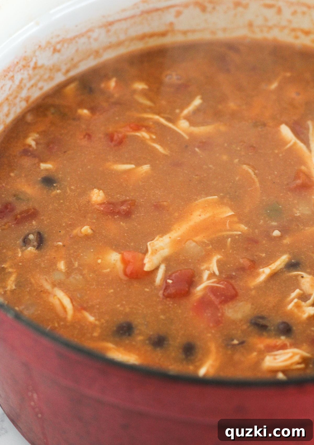 Effortless 20 Minute Chicken Enchilada Soup 7 A large pot filled with rich, simmering chicken enchilada soup, ready to be served.