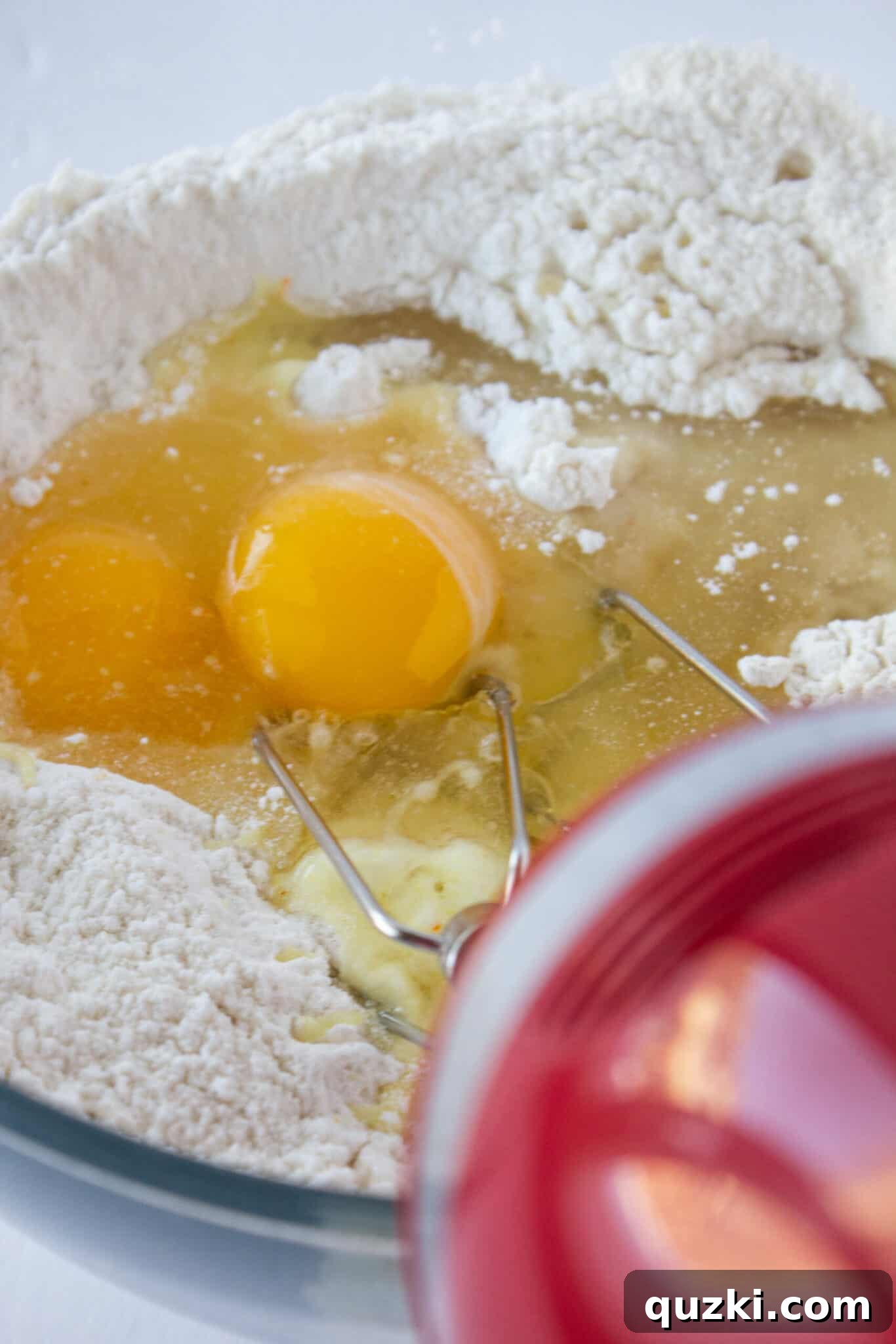 Mixing yellow cake mix, eggs, melted butter, and flour for Chocolate Chip Sheet Cake Cookie dough.