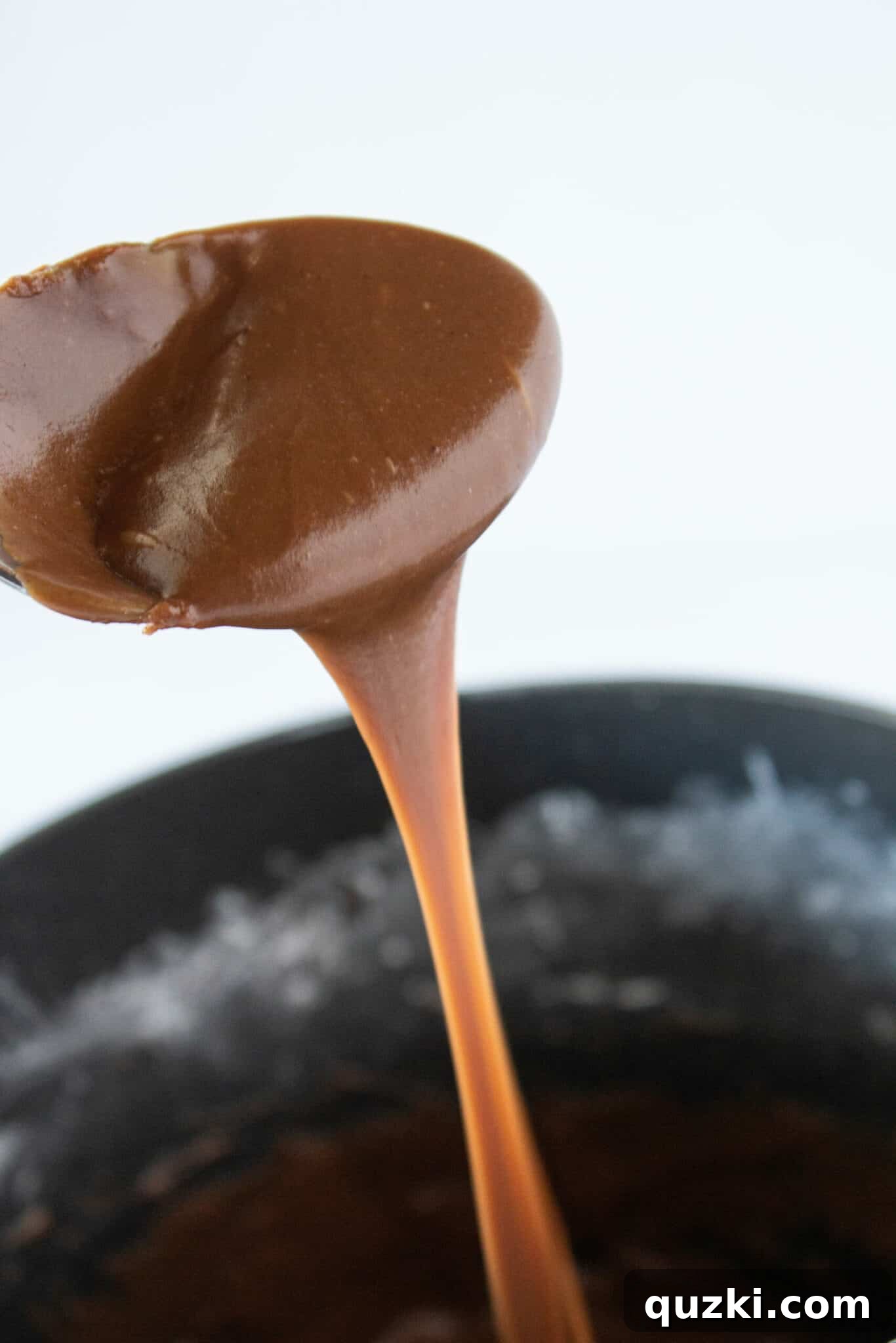 Ingredients for cooked chocolate frosting melting in a saucepan: butter, cocoa powder, and milk.