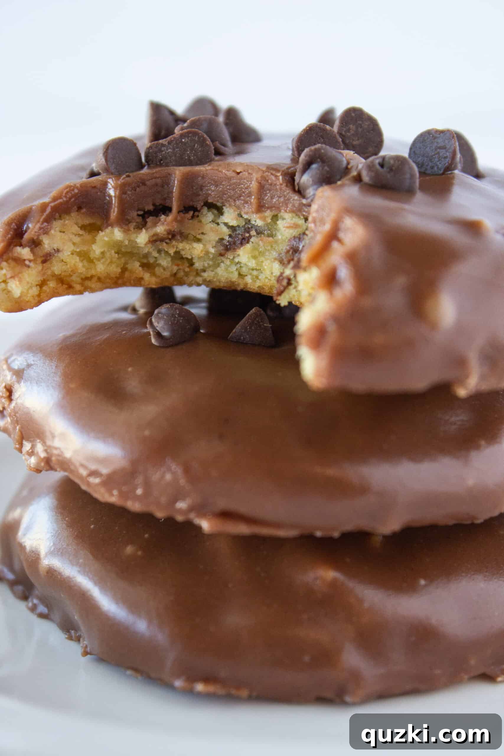 A plate of perfectly frosted Chocolate Chip Sheet Cake Cookies, garnished with extra mini chocolate chips.
