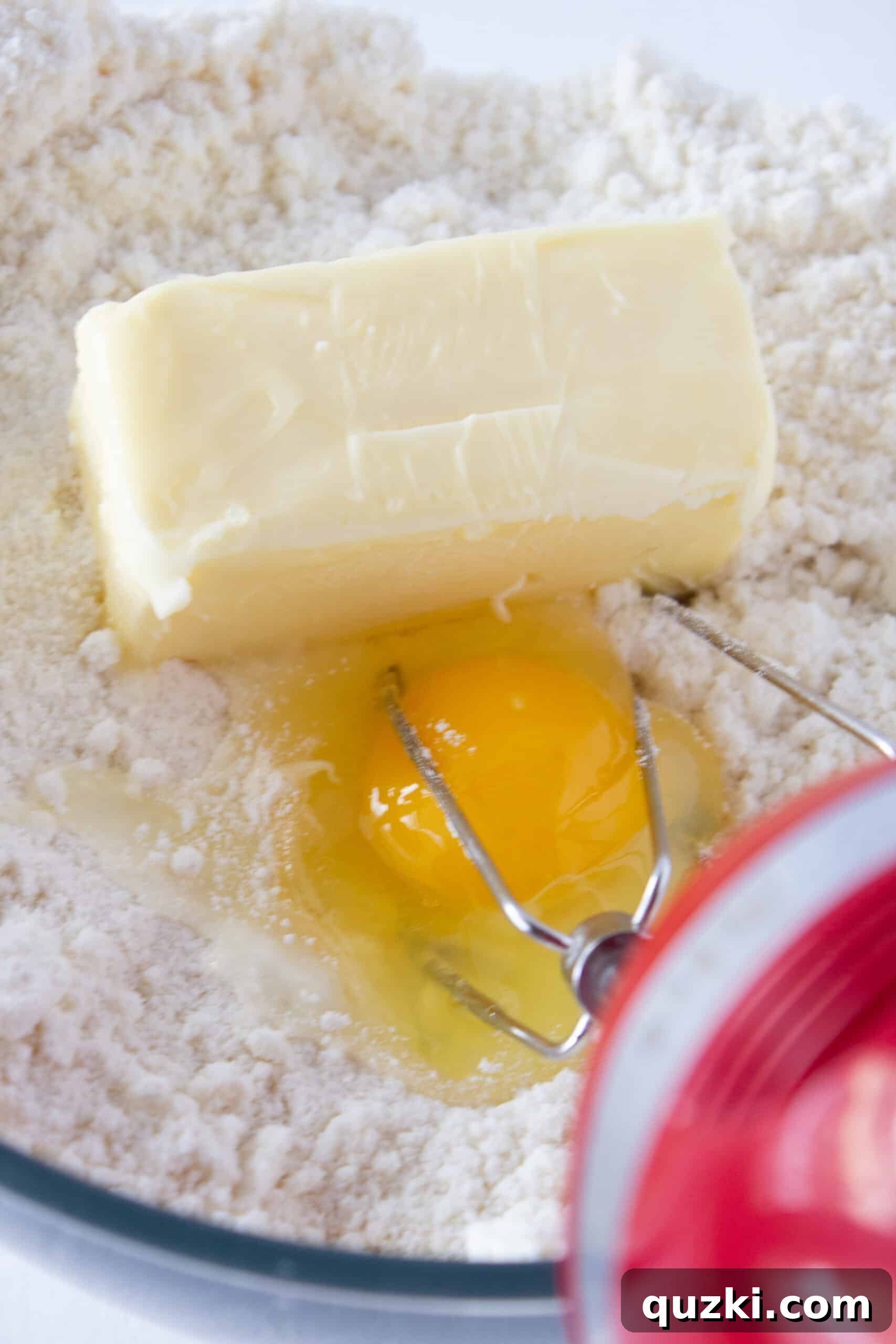 Close-up of golden sugar cookie dough being mixed in a bowl, showcasing its smooth texture, a key step for delicious Lemon Bar Cookie Cups.