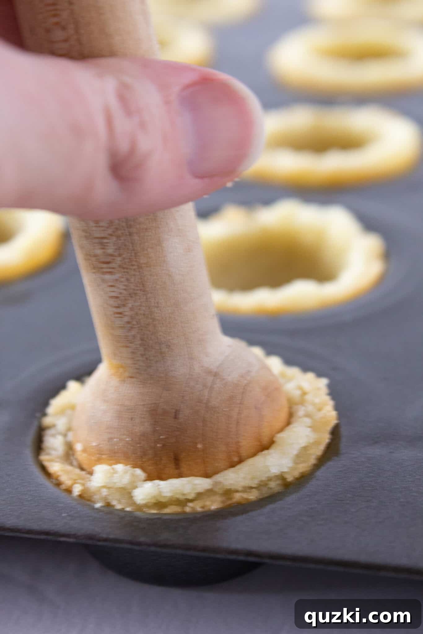 Perfectly baked sugar cookie cups with clearly defined indentations, ready to be filled with the tangy lemon mixture.