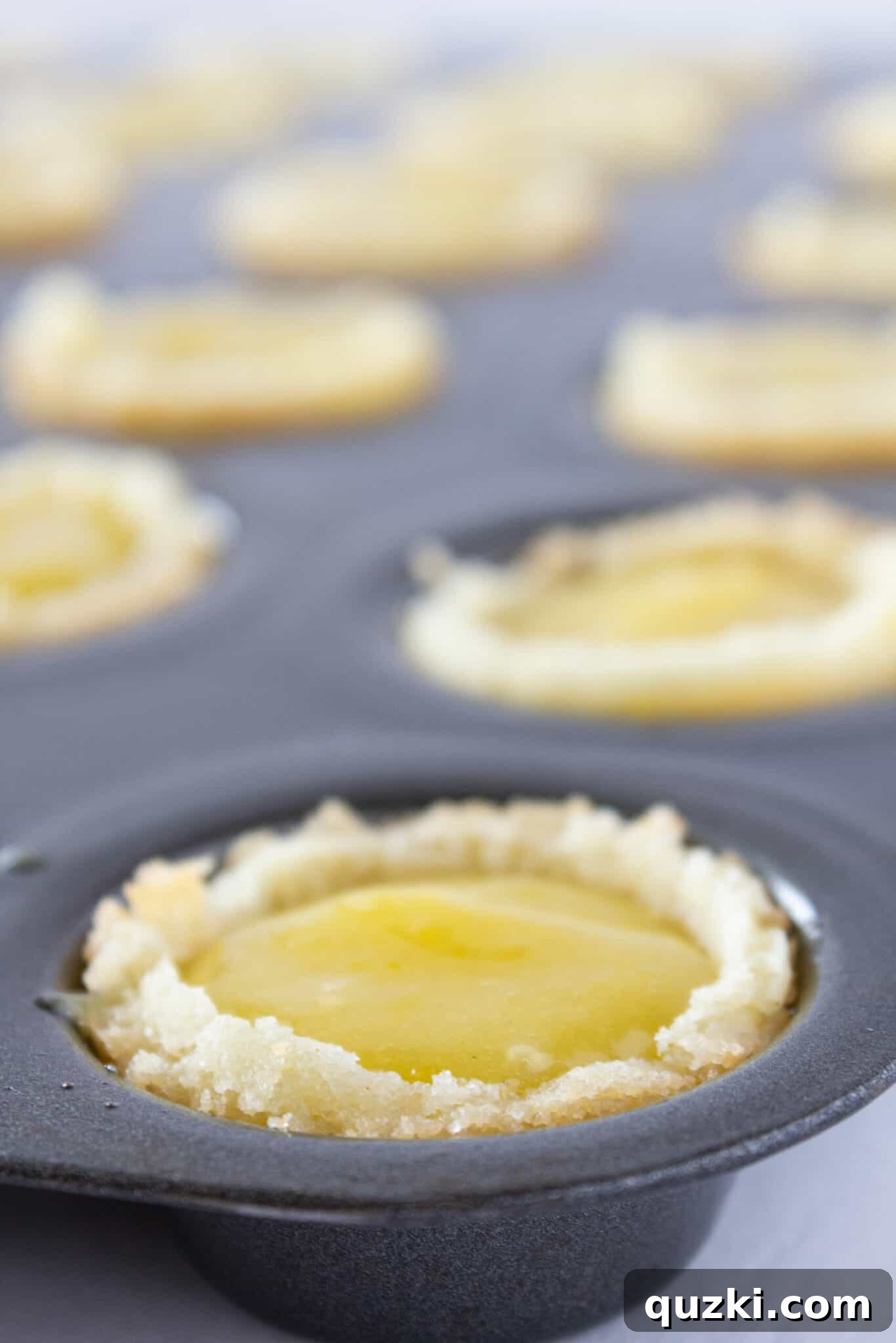 Lemon Bar Cookie Cups being carefully filled with the bright lemon curd, ready for their final decorative touches.