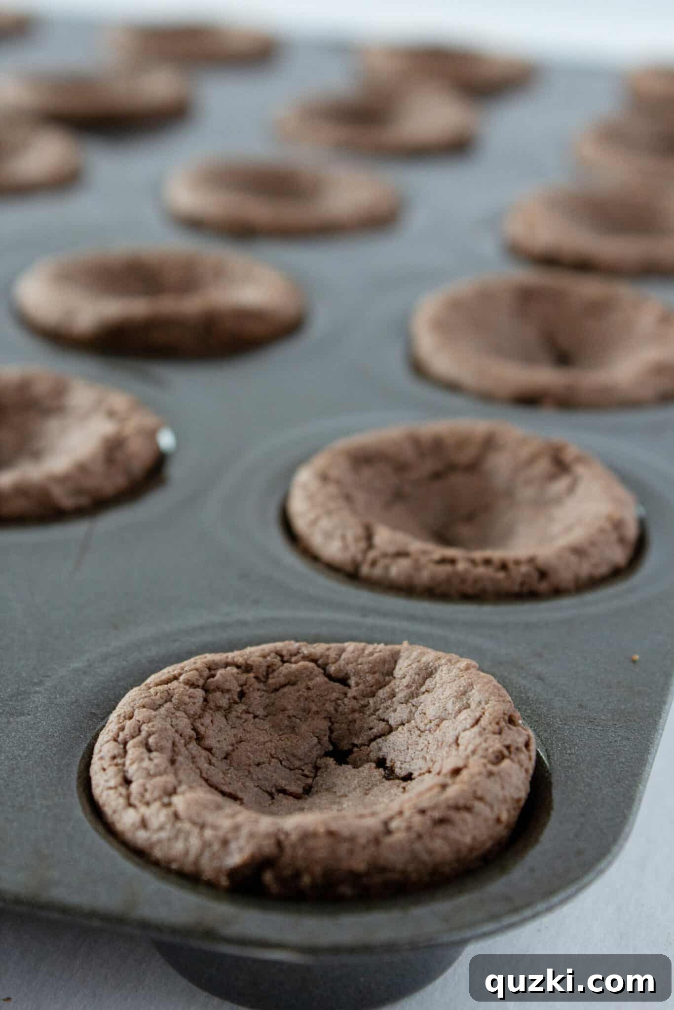 Cake Mix Shortcut Pinata Cookies 7 The baked cookie cups immediately after coming out of the oven, ready for the indentation process.