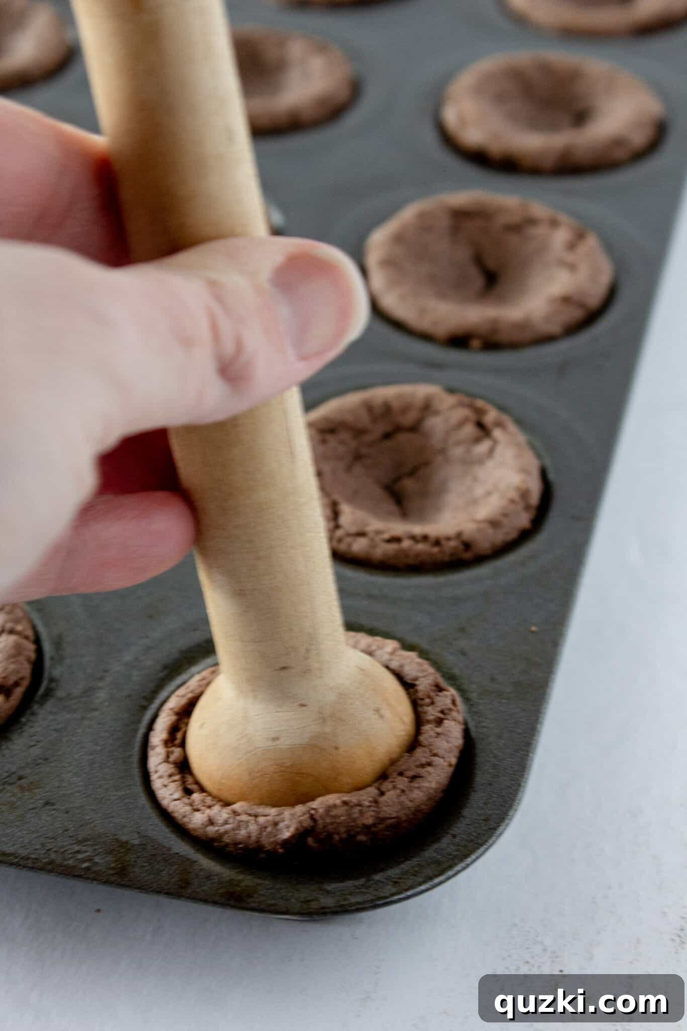 Cake Mix Shortcut Pinata Cookies 8 Creating the central indentation in each cookie cup, which will hold the candy filling.