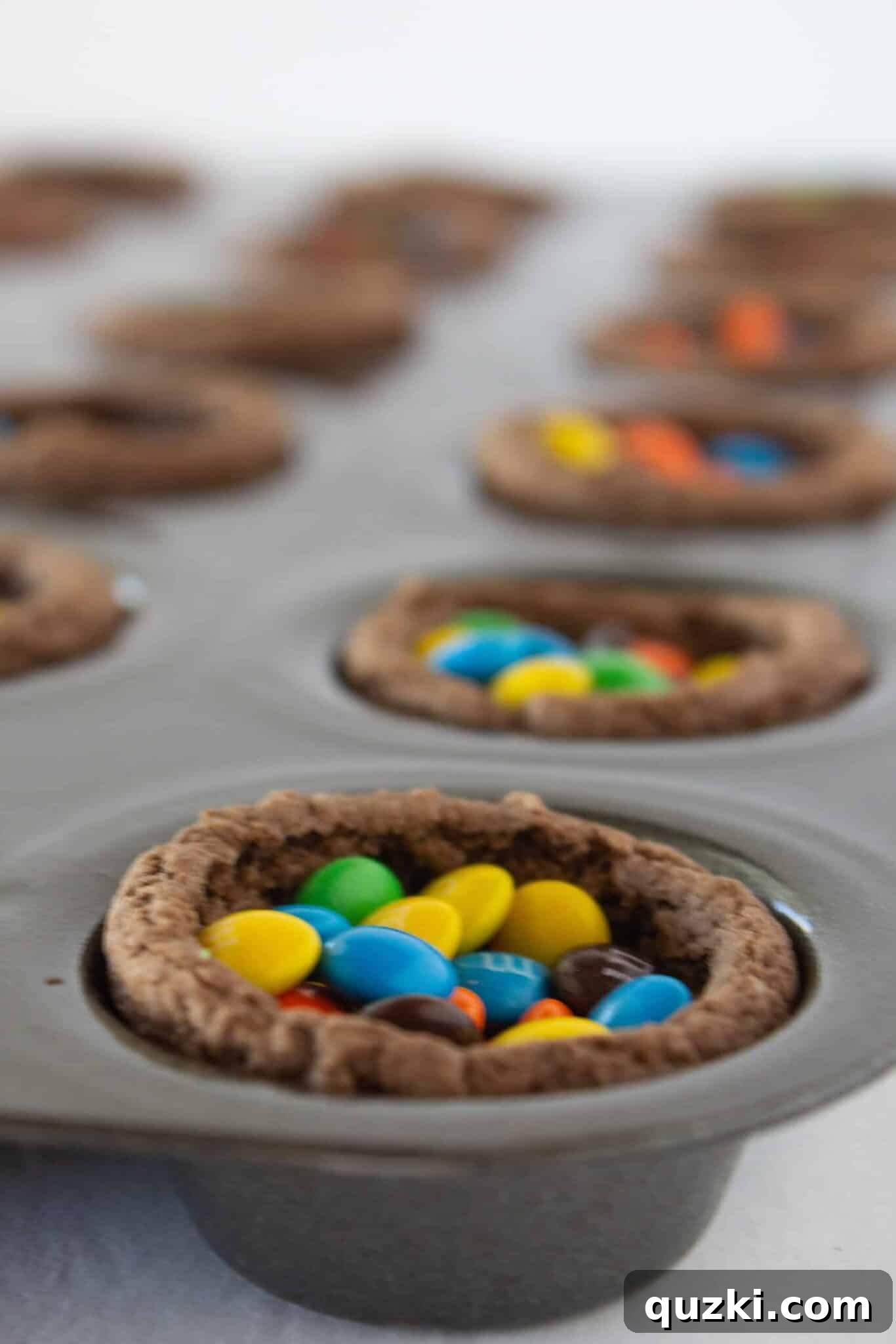 Cake Mix Shortcut Pinata Cookies 9 Filling the cookie cups with a generous amount of mini M&M's, anticipating the delightful surprise.