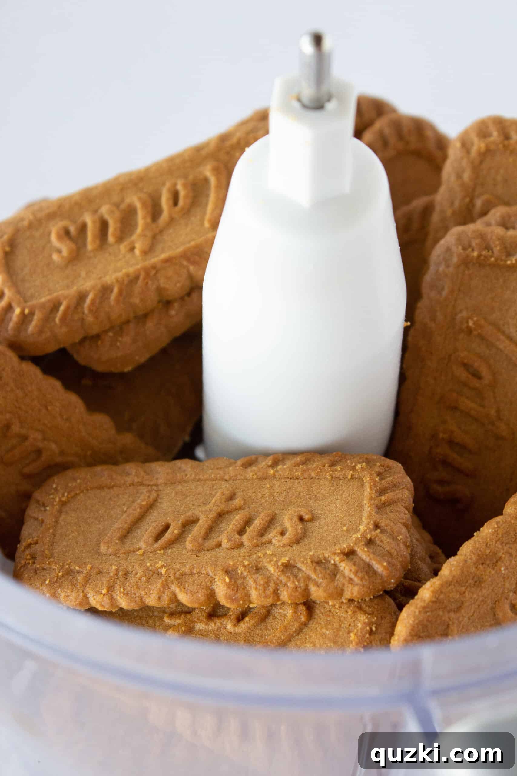 Decadent Cookie Butter No-Bake Cheesecake 4 Biscoff cookies being pulsed in a food processor for the cheesecake crust