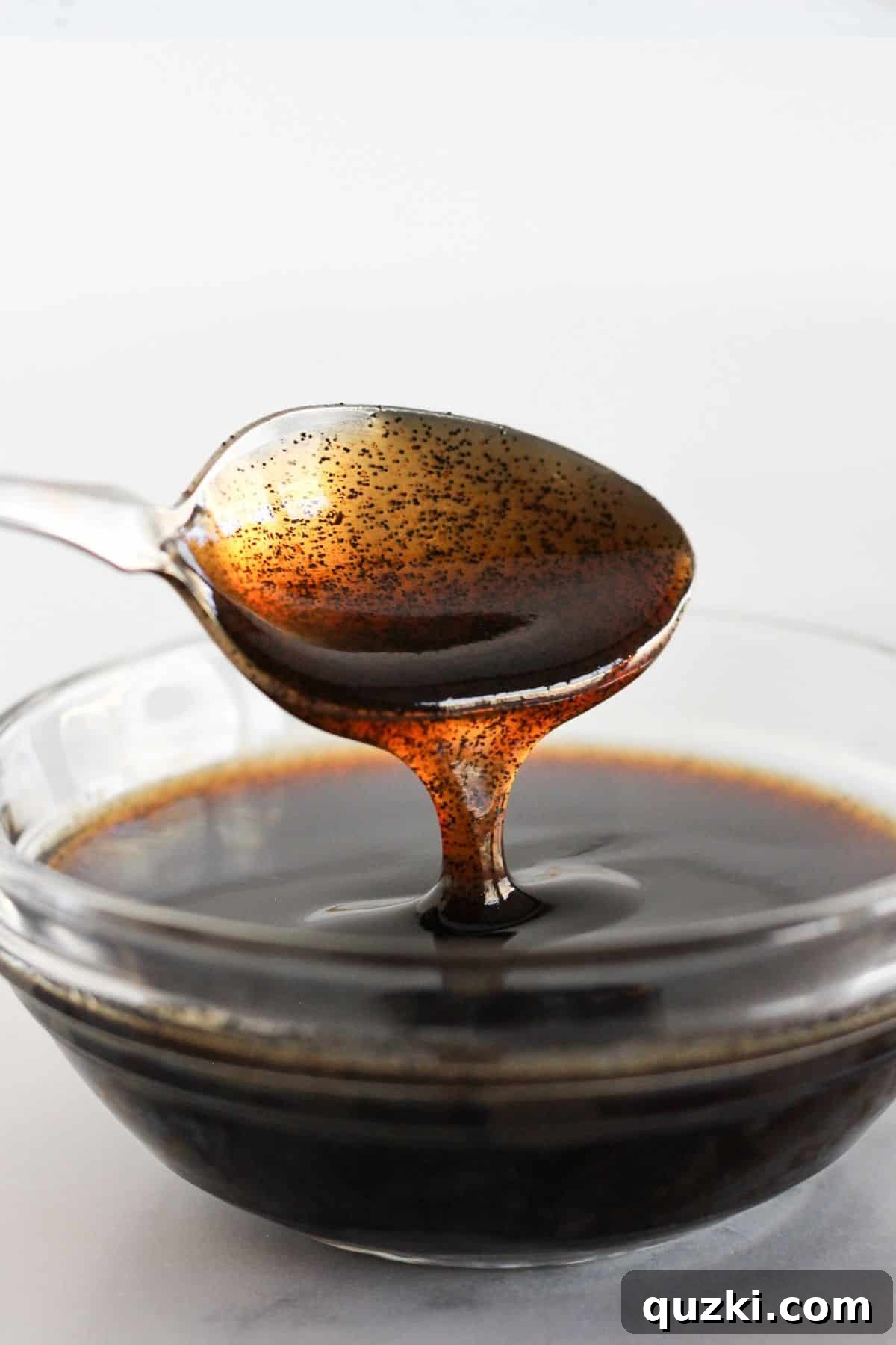 Why I Use Vanilla Bean Paste as a Time-Saving Baking Shortcut 2 Vanilla bean paste in a clear bowl with a spoon.