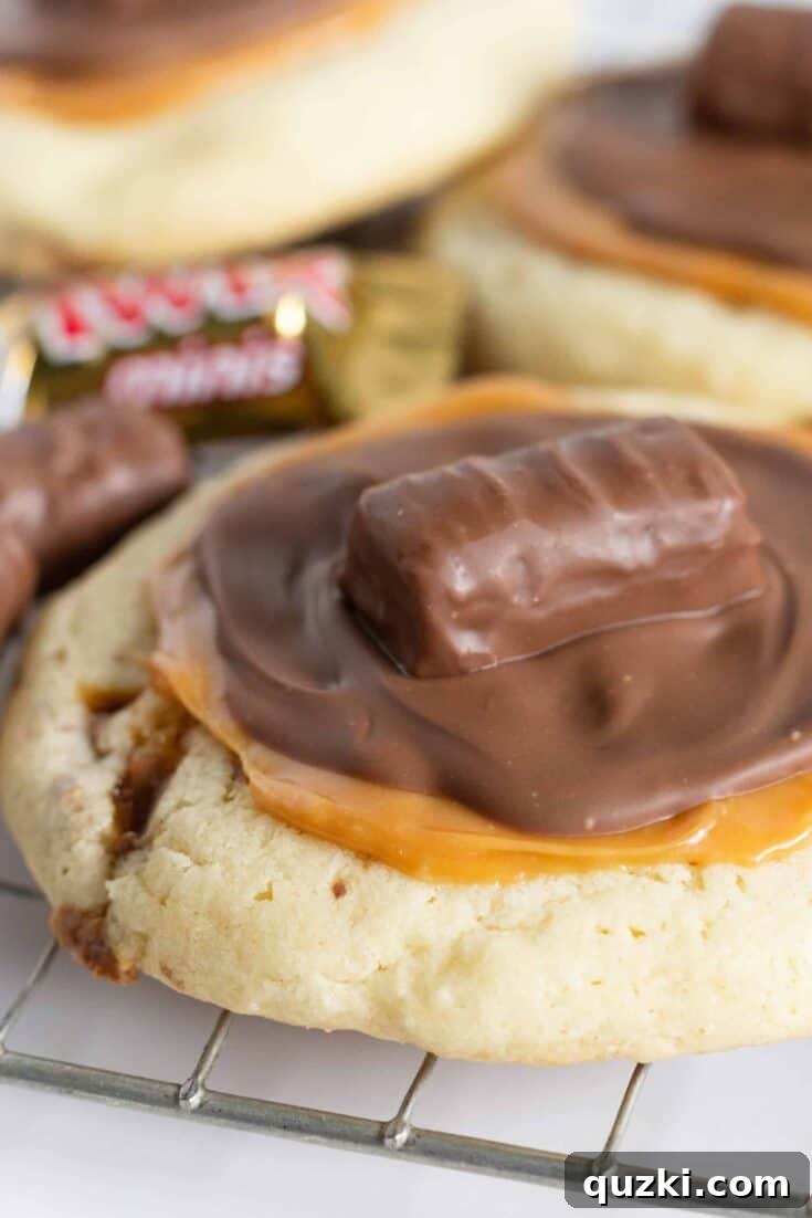 Cake Mix Cookies with Twix candy bars in and on them.