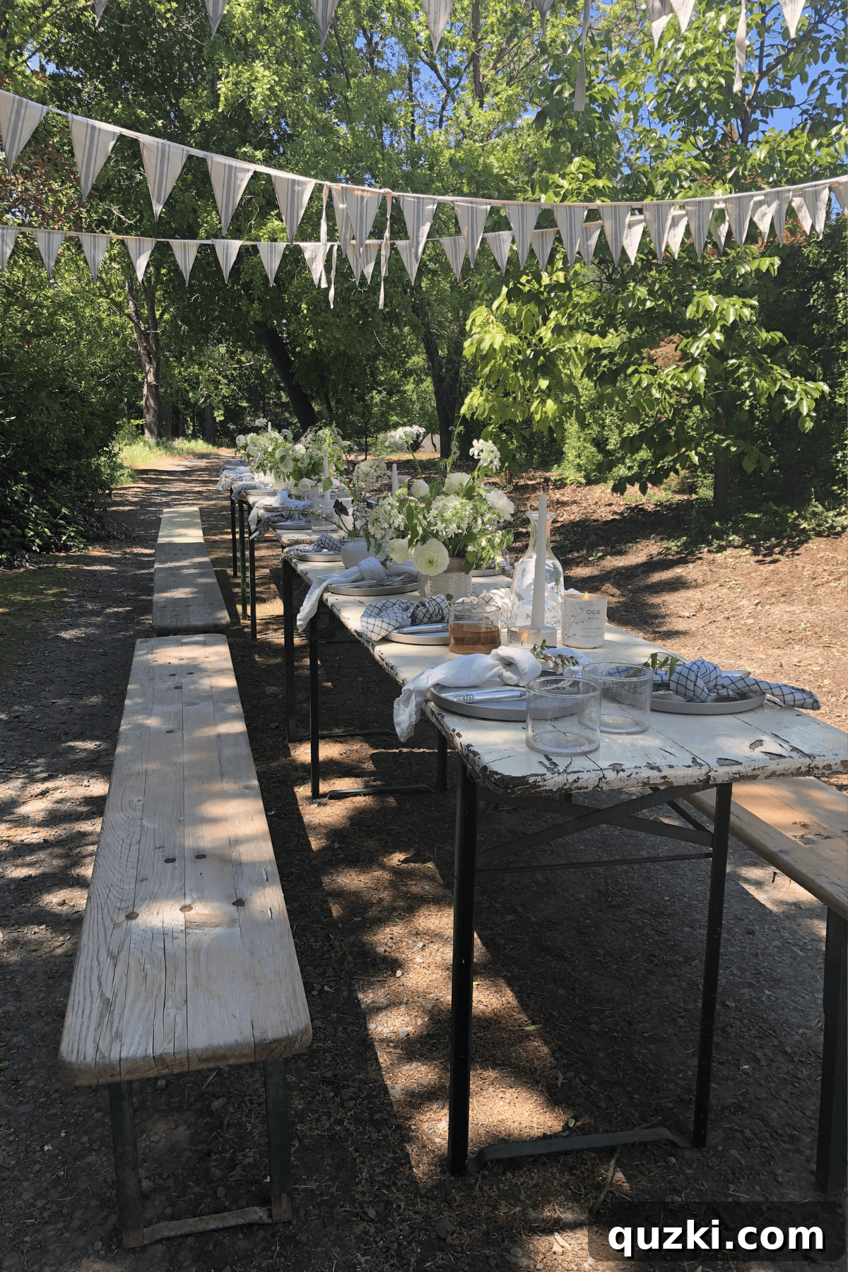 Why Dinner Parties Matter: Tips for Memorable Evenings 2 A wooden table and benches set up for dinner in the trees.