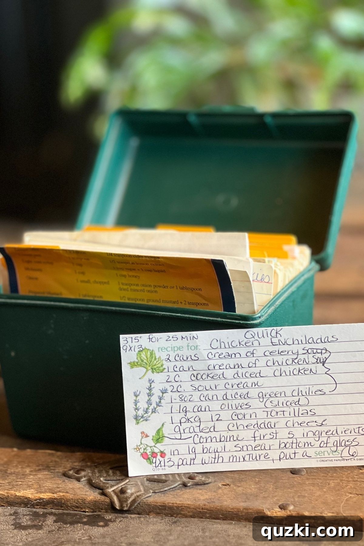 A green recipe box with handwritten recipes.