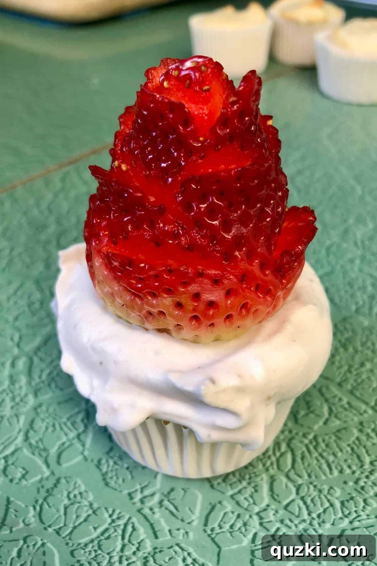 Why the Cupcakes Weren't Really the Point 3 A cupcake with a strawberry rose on top.
