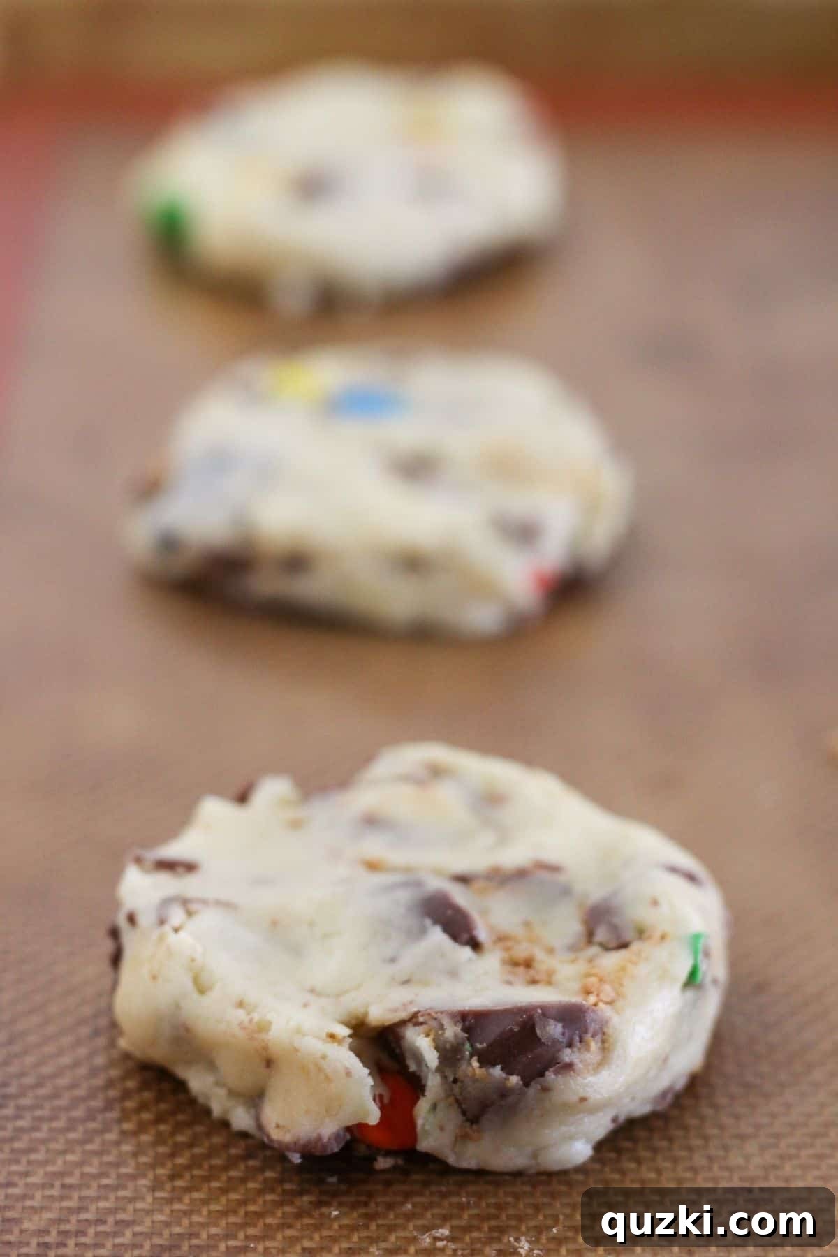 Halloween Candy Cookies Made with Cake Mix 5 Halloween candy cookie dough discs on a sheet pan.