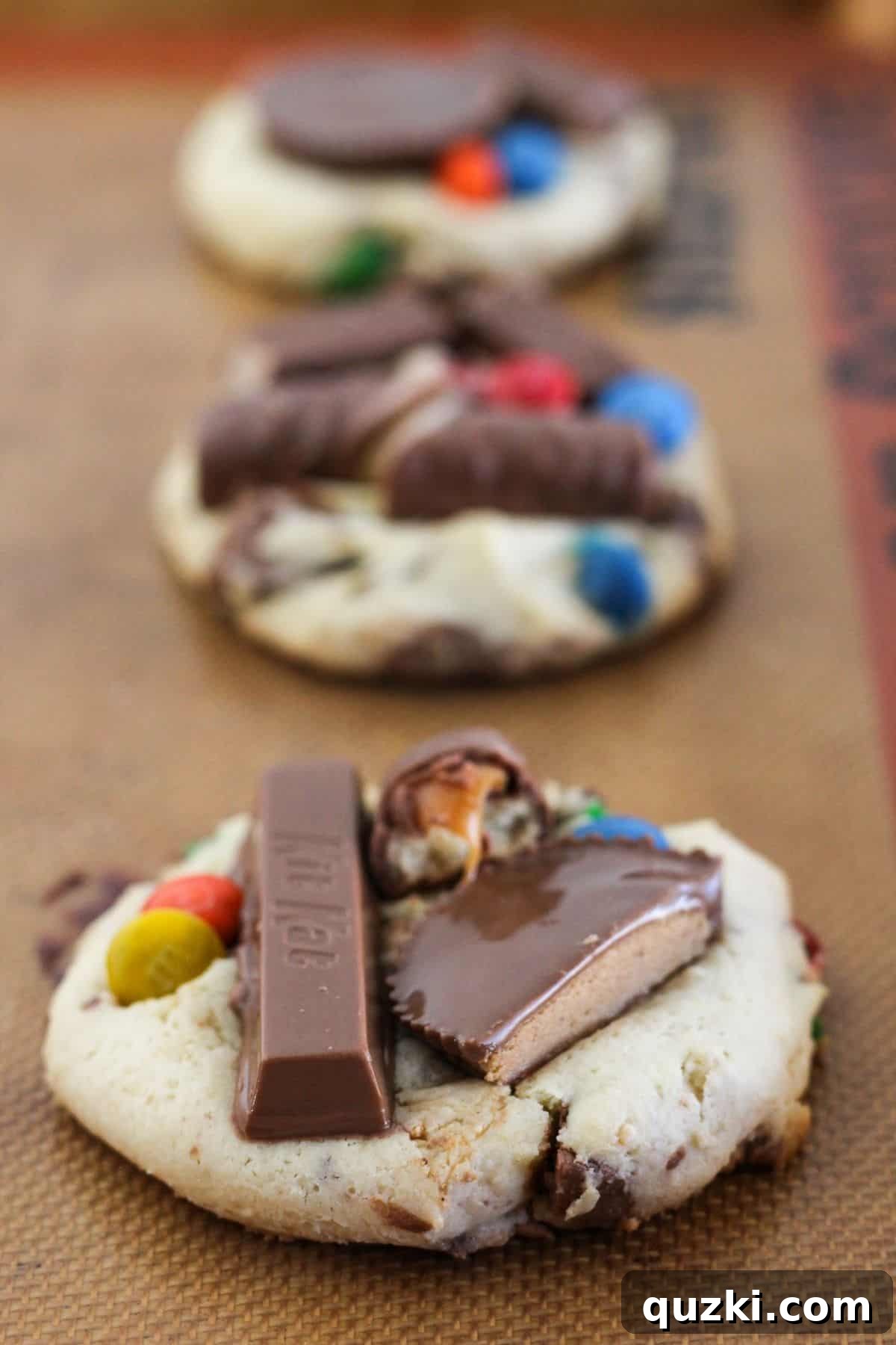 Halloween Candy Cookies Made with Cake Mix 7 Adding additional candy to the top of Halloween Candy Cookies.
